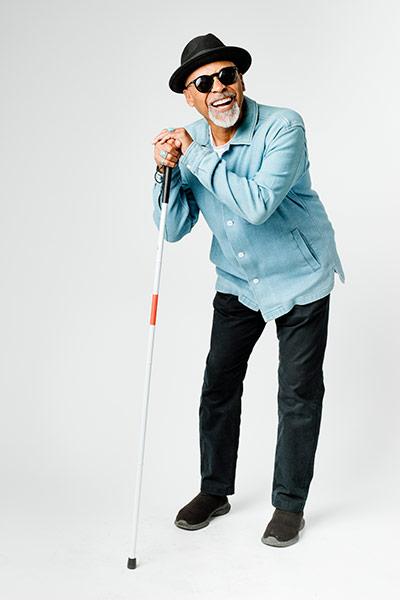 Senior blind man walking with a cane
