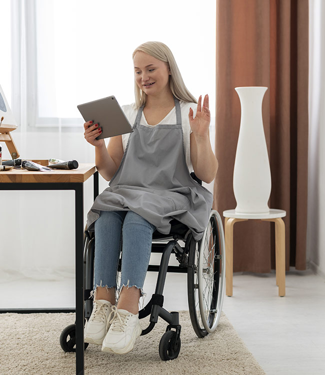 Young lady in a wheelchair using a tablet
