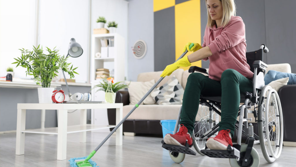 Lady doing cleaning in a wheel chair